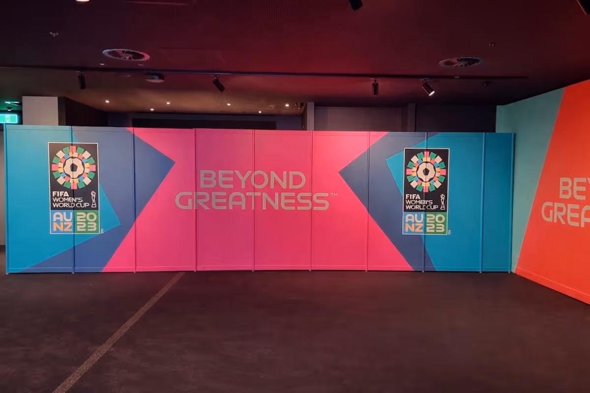 Indoor display with FIFA Women’s World Cup 2023 logos and the slogan 'Beyond Greatness' on colorful panels.