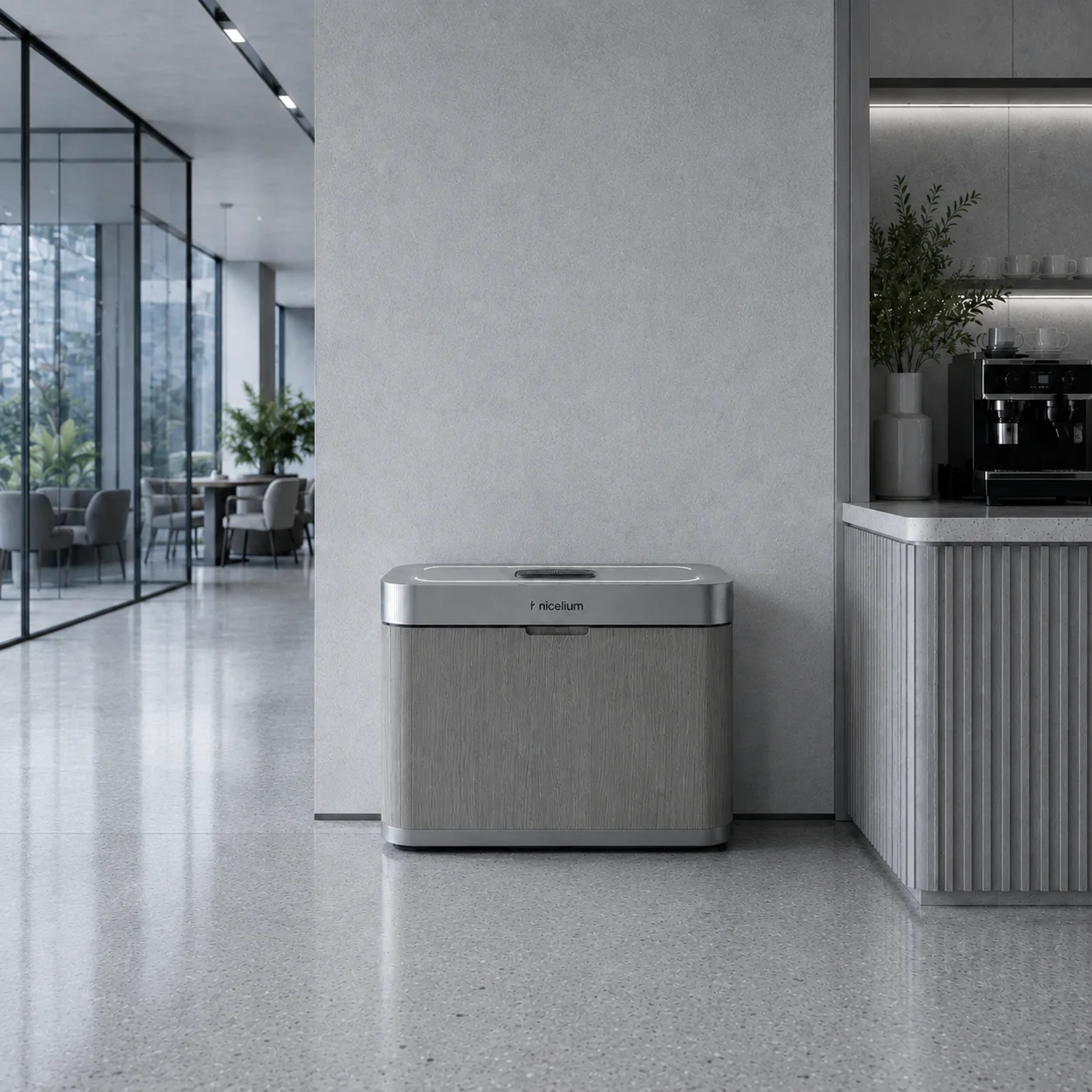 Modern square trash bin with wood and metal finish in sleek lobby area near a coffee machine.