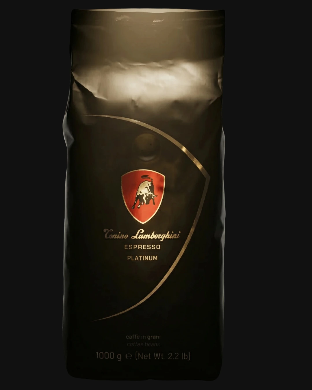 Black and white profile portrait of a person with curly hair wearing a small hoop earring and a casual shirt, against a black background.