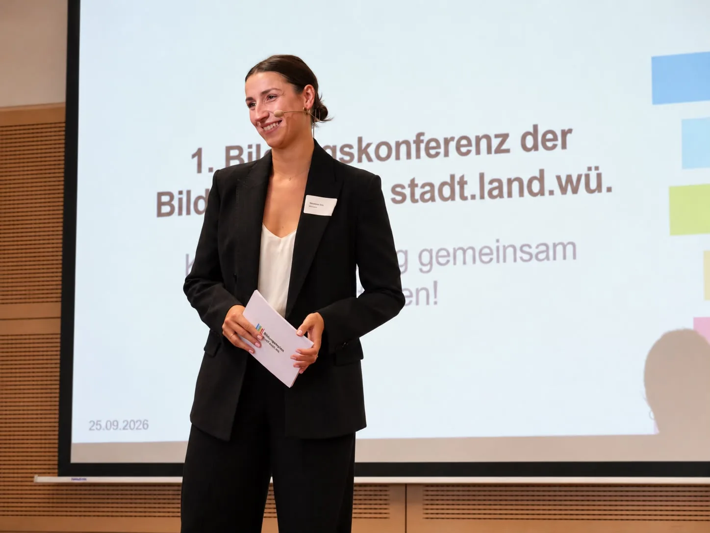 Madeleine Etti hosting an education conference