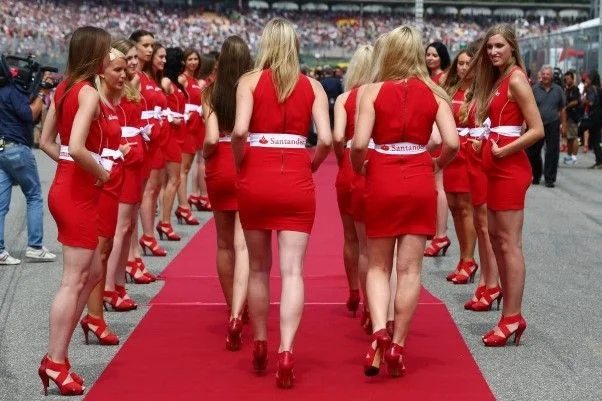 Grid girls in red dresses on the red carpet on the starting grid at the Hockenheimring