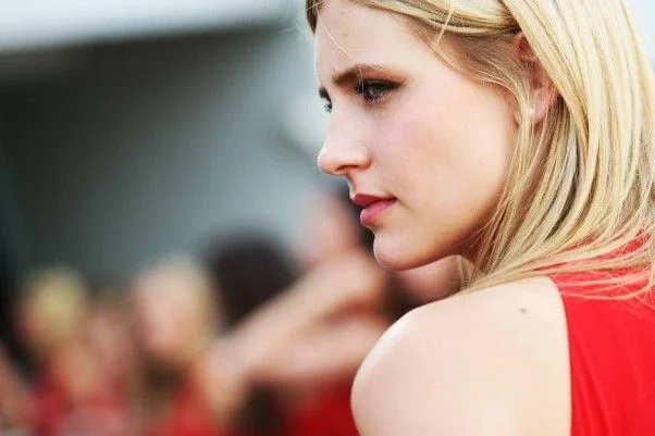 Blonde grid girl in profile in a red Santander uniform at the 2014 German Grand Prix