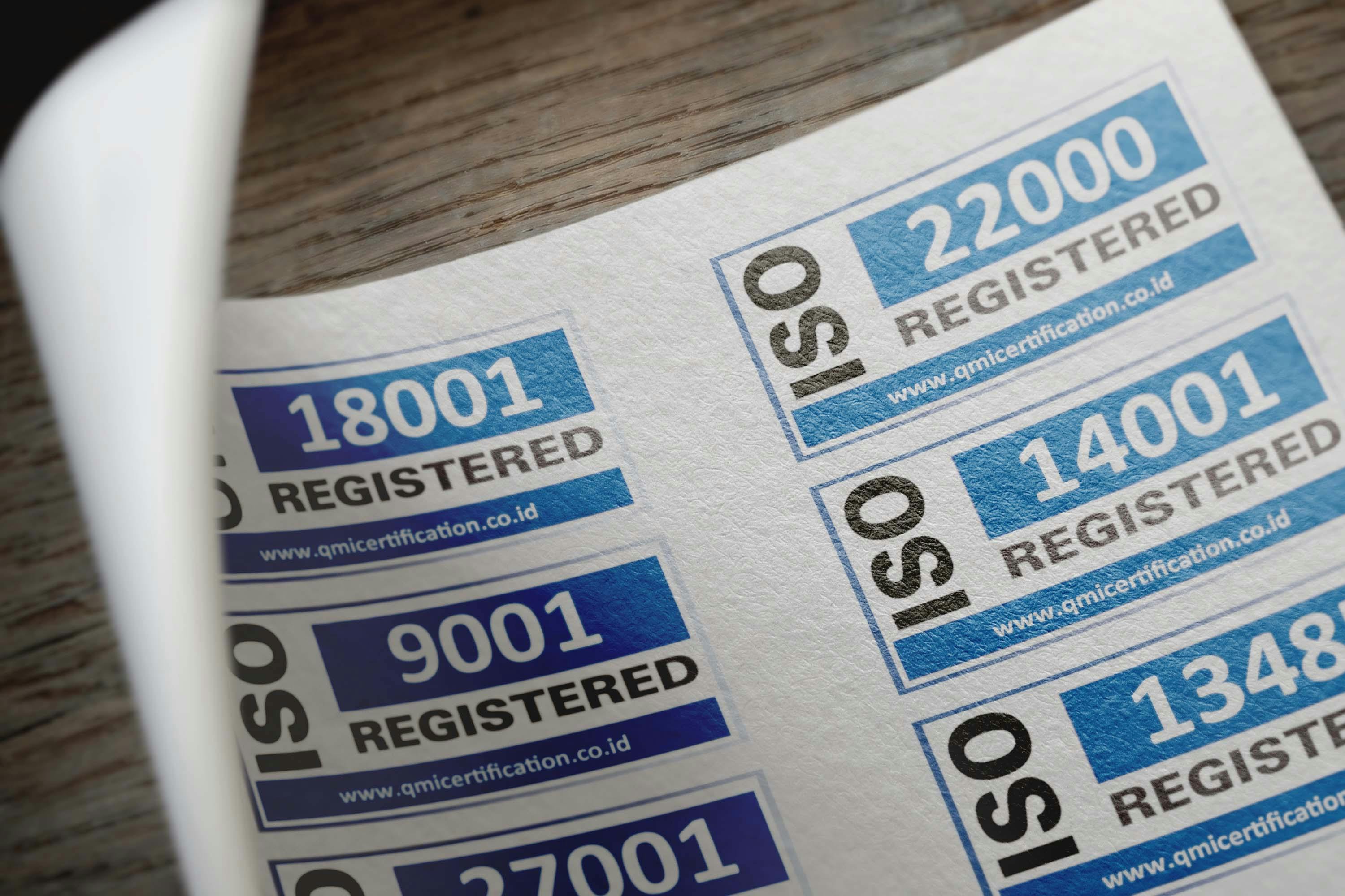 ISO certification stickers with registration numbers on paper — verification frameworks for sustainability disclosure