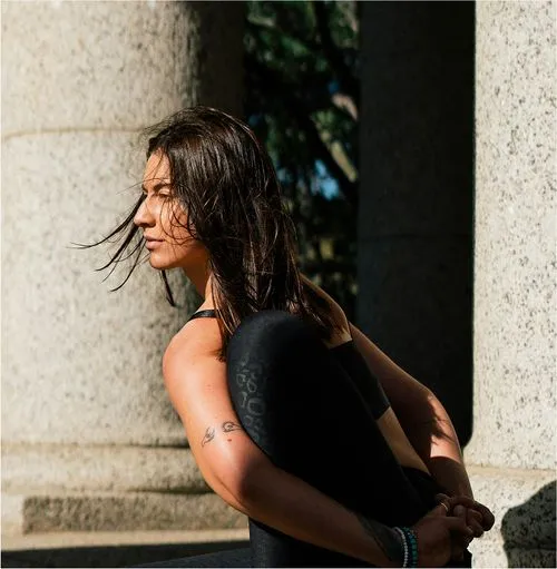 Three women smiling in yoga outfits