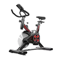 Bicicleta estática negra con detalles en rojo y asiento ajustable.