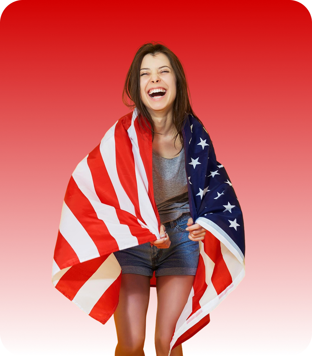 Happy young woman wrapped in a large American flag with red gradient background.