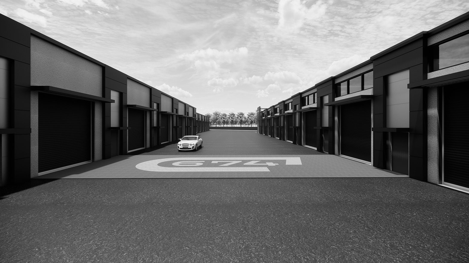 Modern warehouse units with closed black garage doors and a white car in the open driveway.