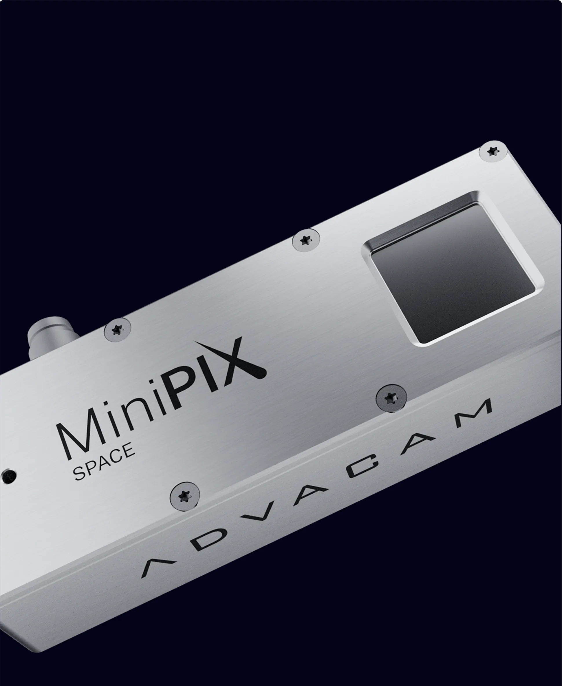 Close-up of a silver metallic device labeled MiniPIX SPACE with ADVACAM branding, featuring screws and a small square sensor or window.