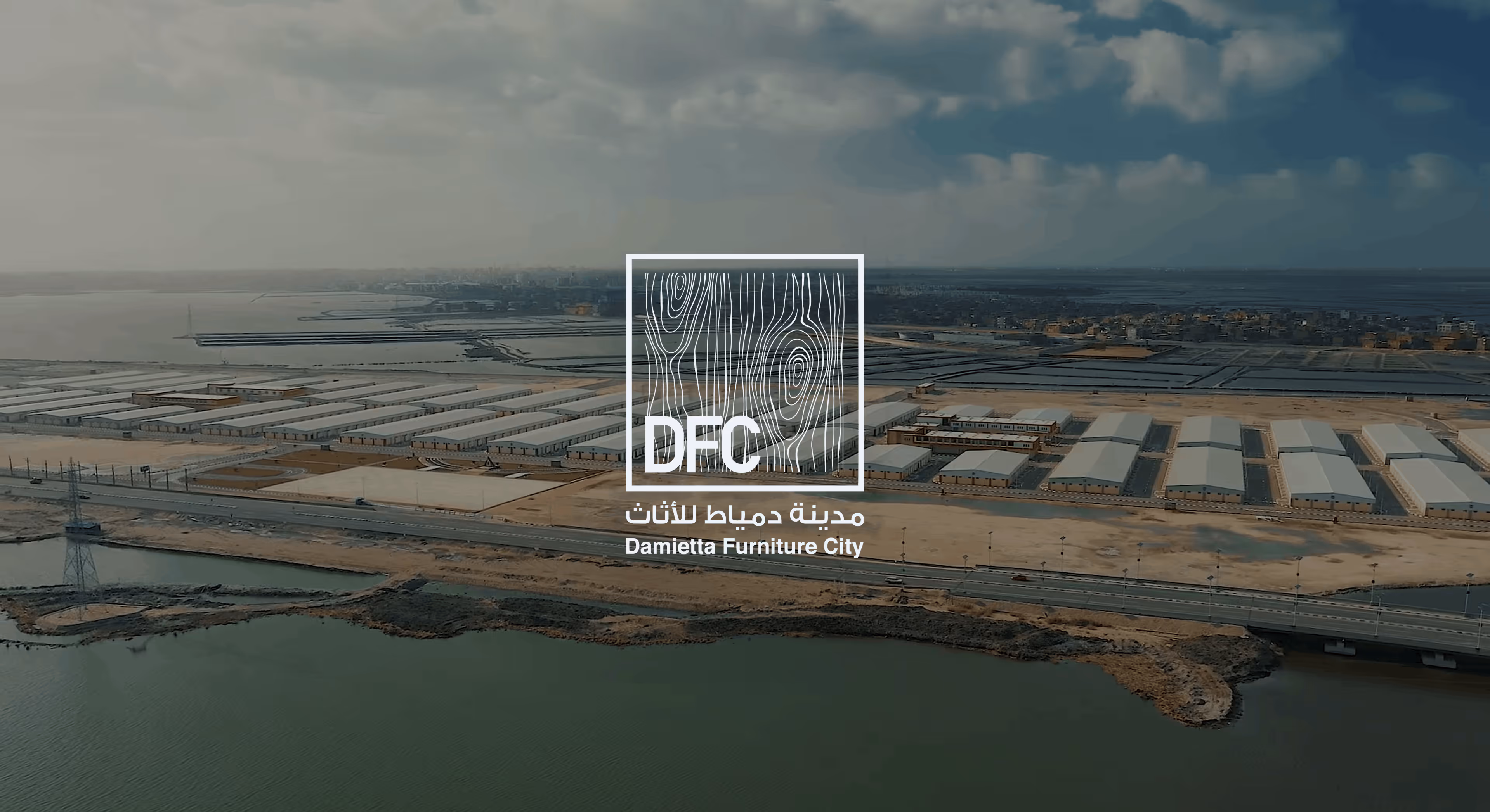 Aerial view of industrial buildings and water near a road at Damietta Furniture City.