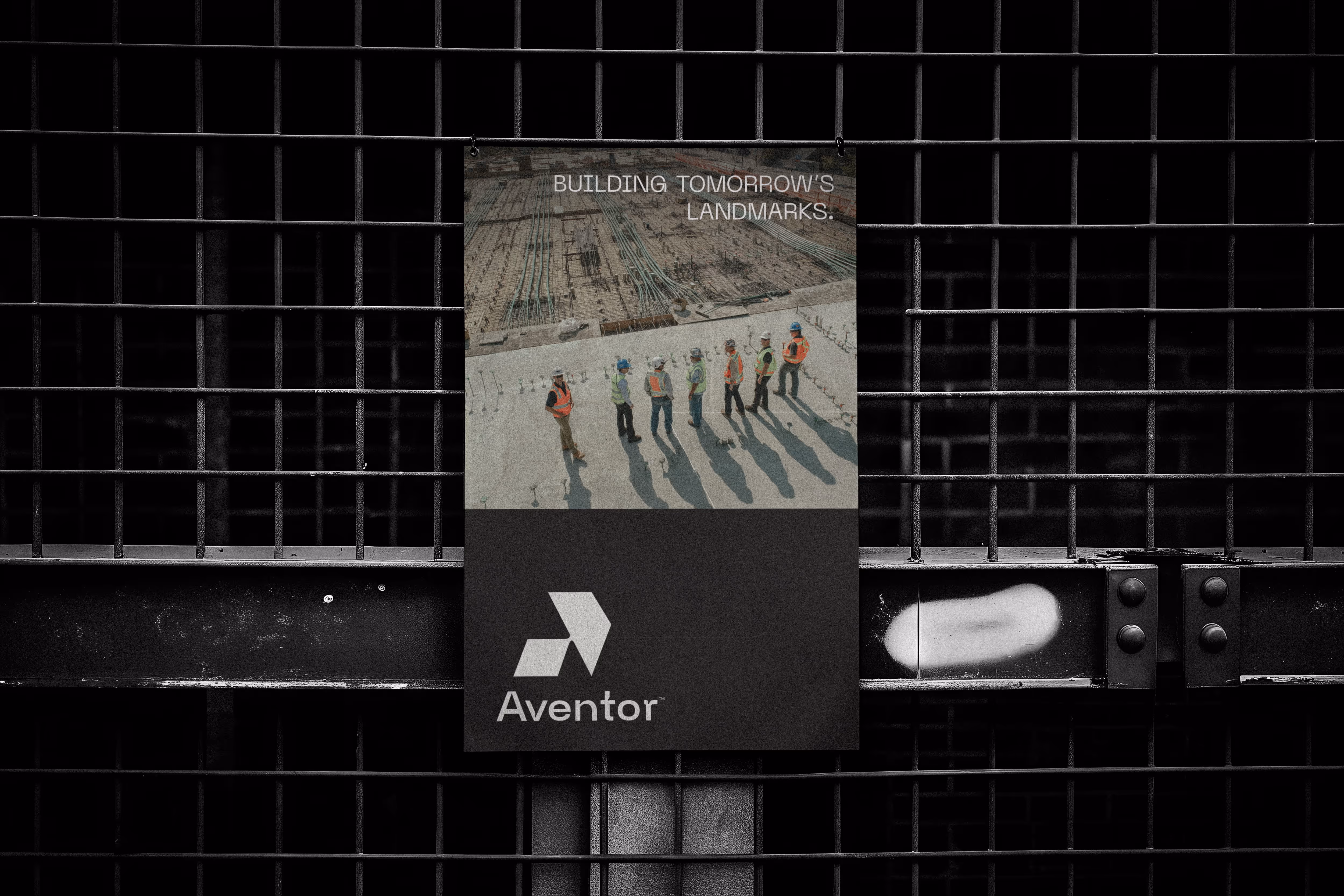 Poster with workers on a construction site and text reading 'Building tomorrow's landmarks' and 'Aventor'.