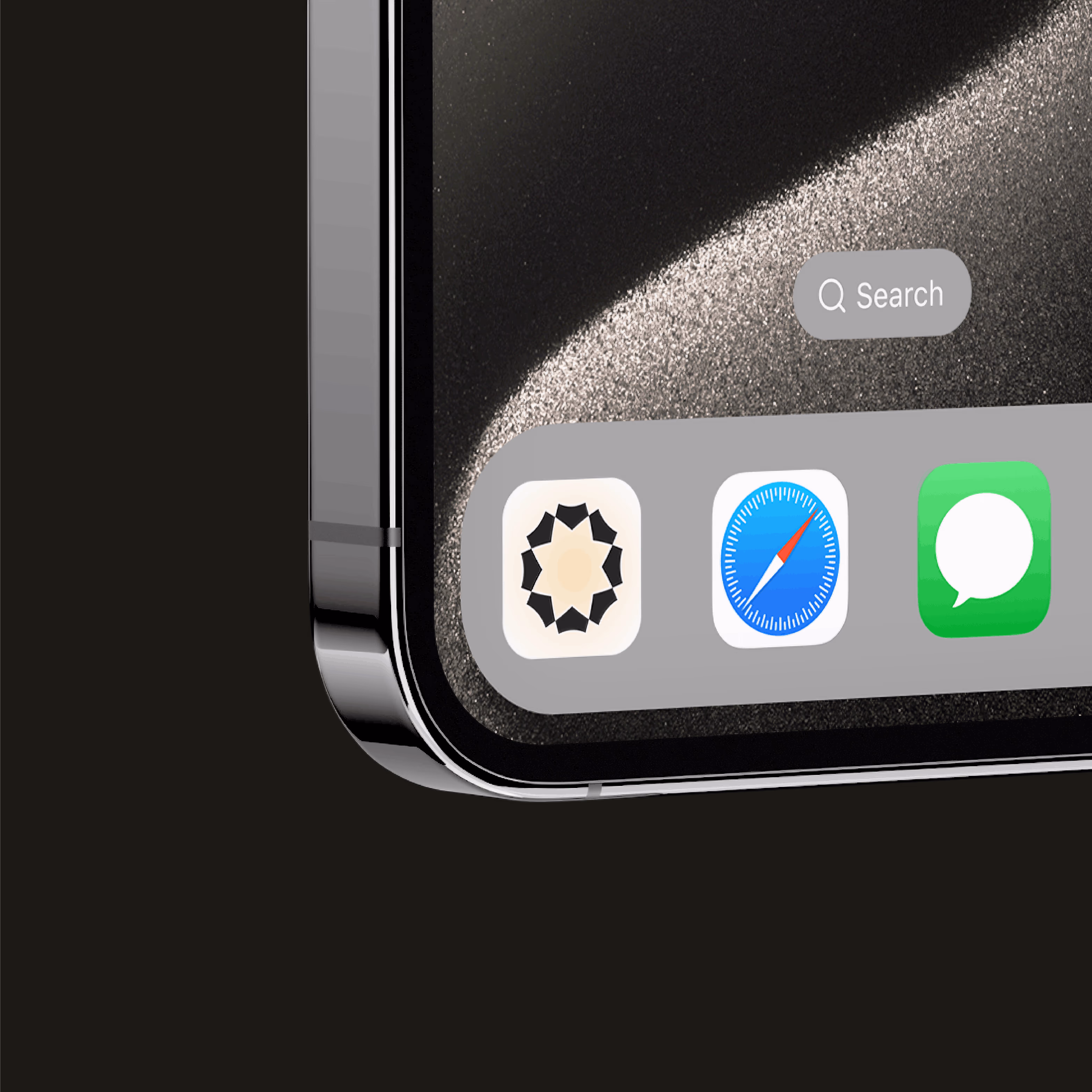 Close-up of a smartphone corner showing three app icons and a search bar on the screen.
