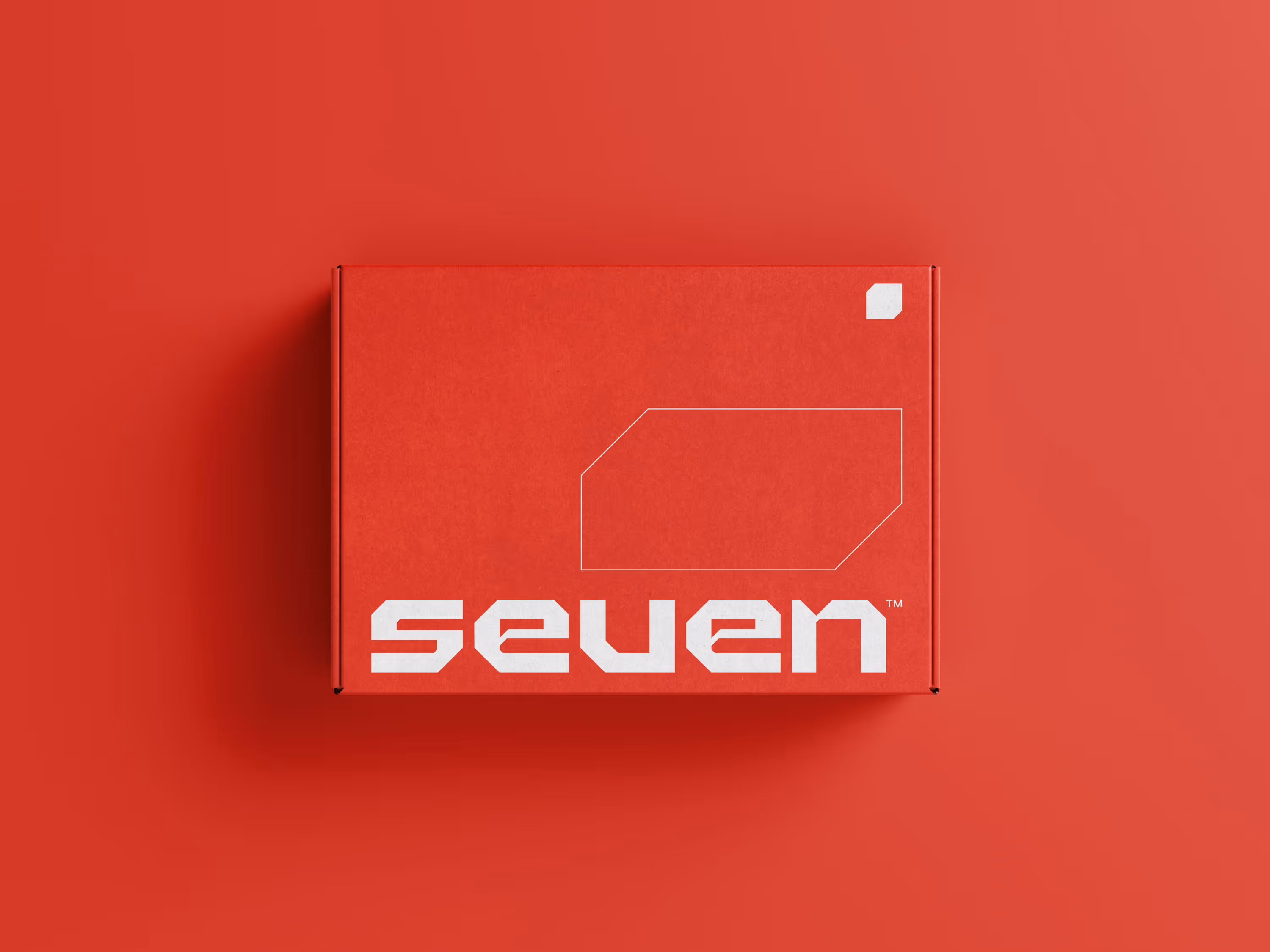 Red rectangular box with the word 'seven' in bold white on the front, set against a red background.