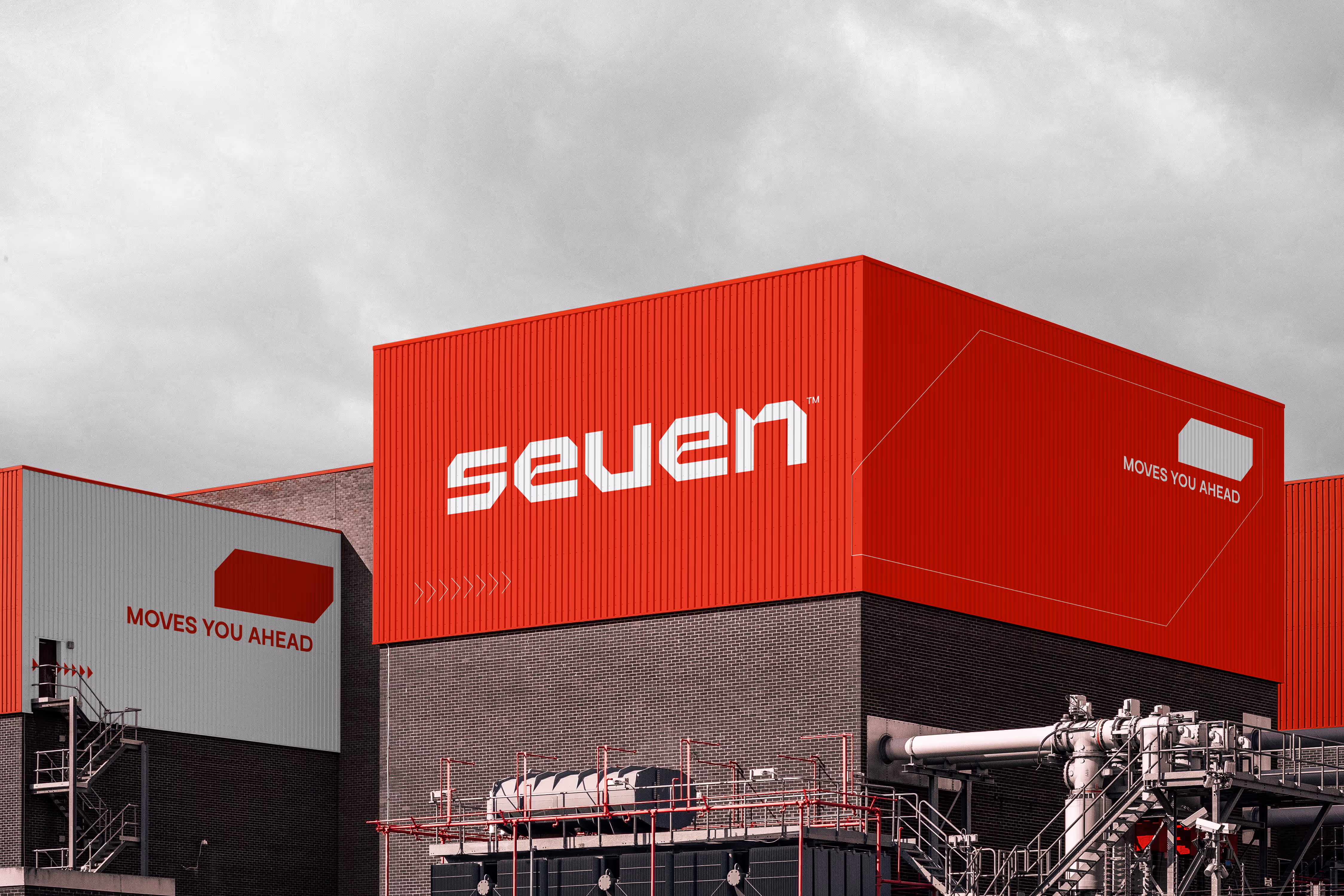 Industrial building with red upper walls, featuring the word 'seven' and slogan 'Moves You Ahead'.