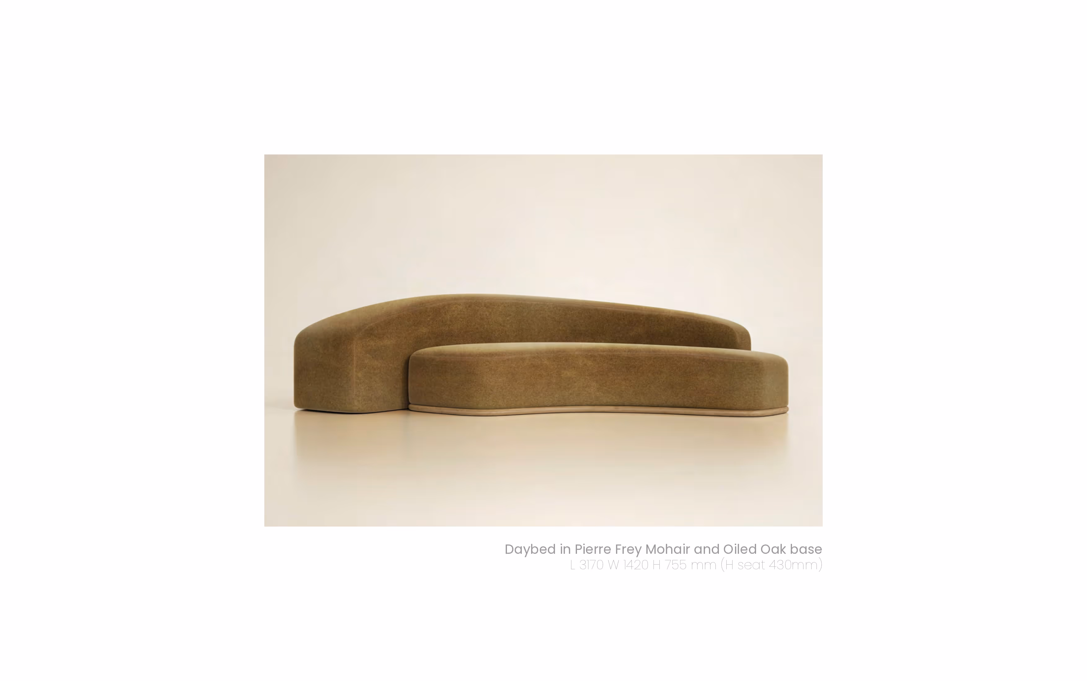 Modern curved brown daybed with low backrest upholstered in soft fabric on a plain floor.