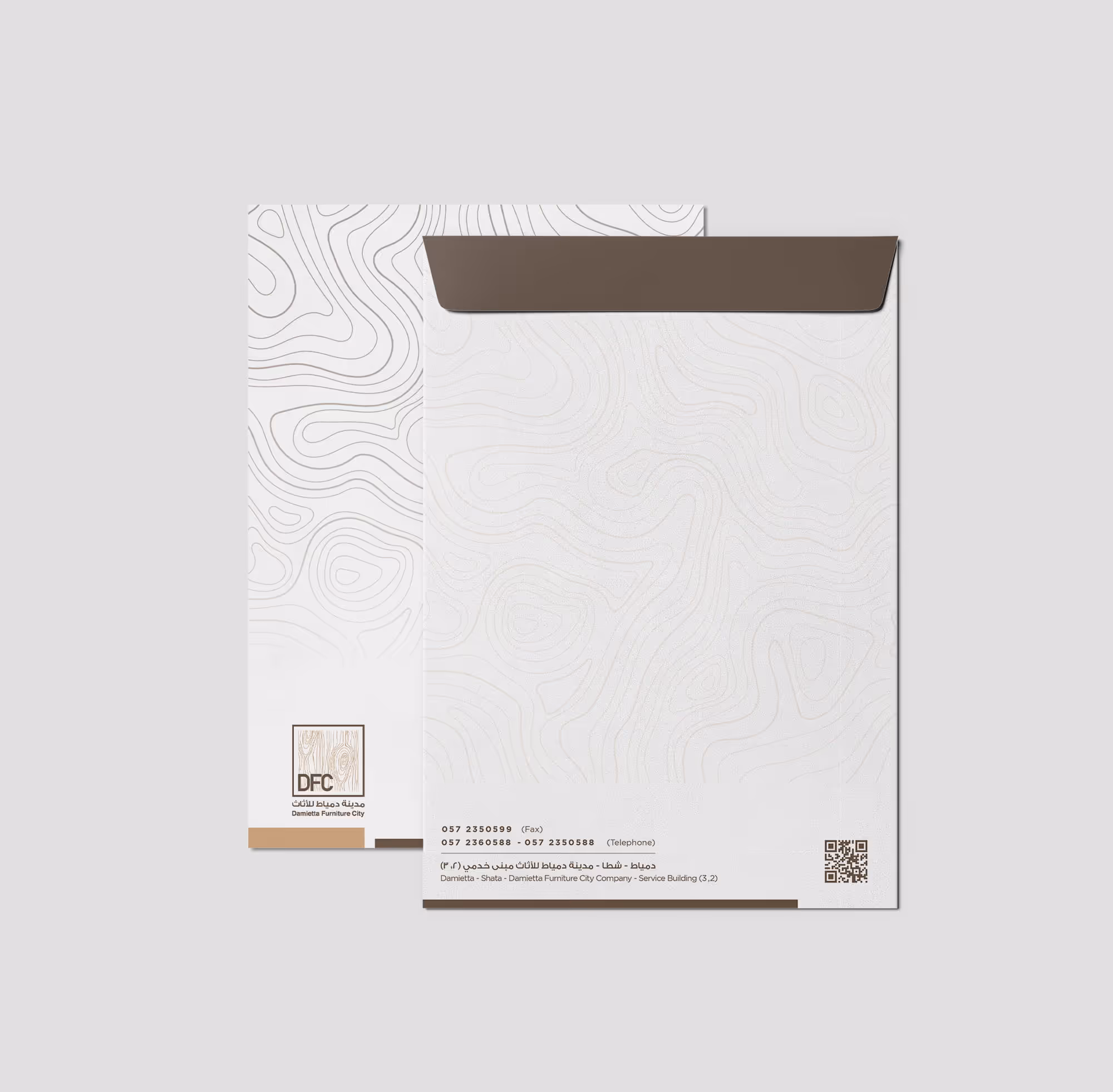 White letterhead and envelope with abstract contour lines and brown flap from Damietta Furniture City.