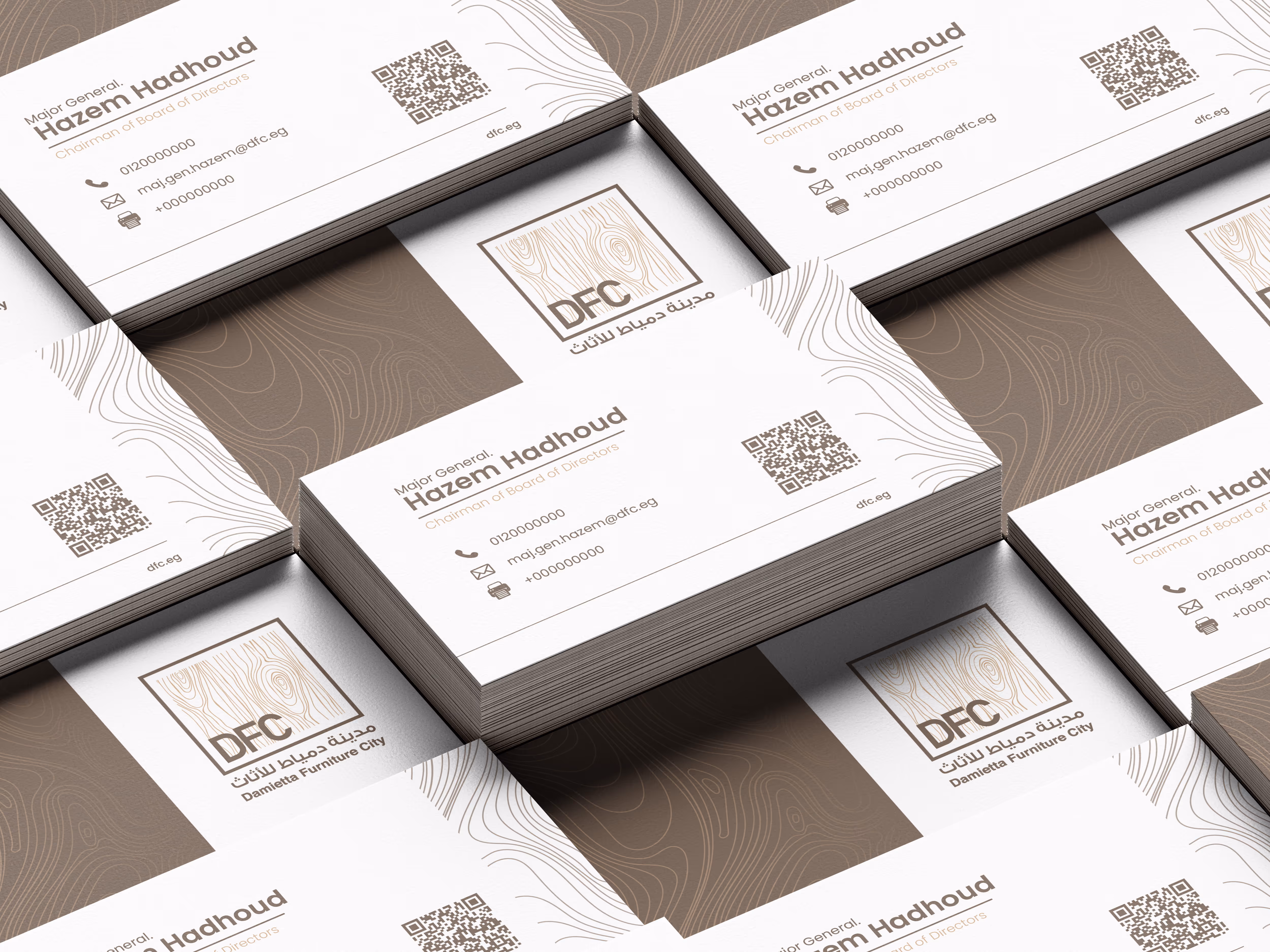 Stacks of DFC business cards with wood grain logo and contact details for Hazem Hadhoud.