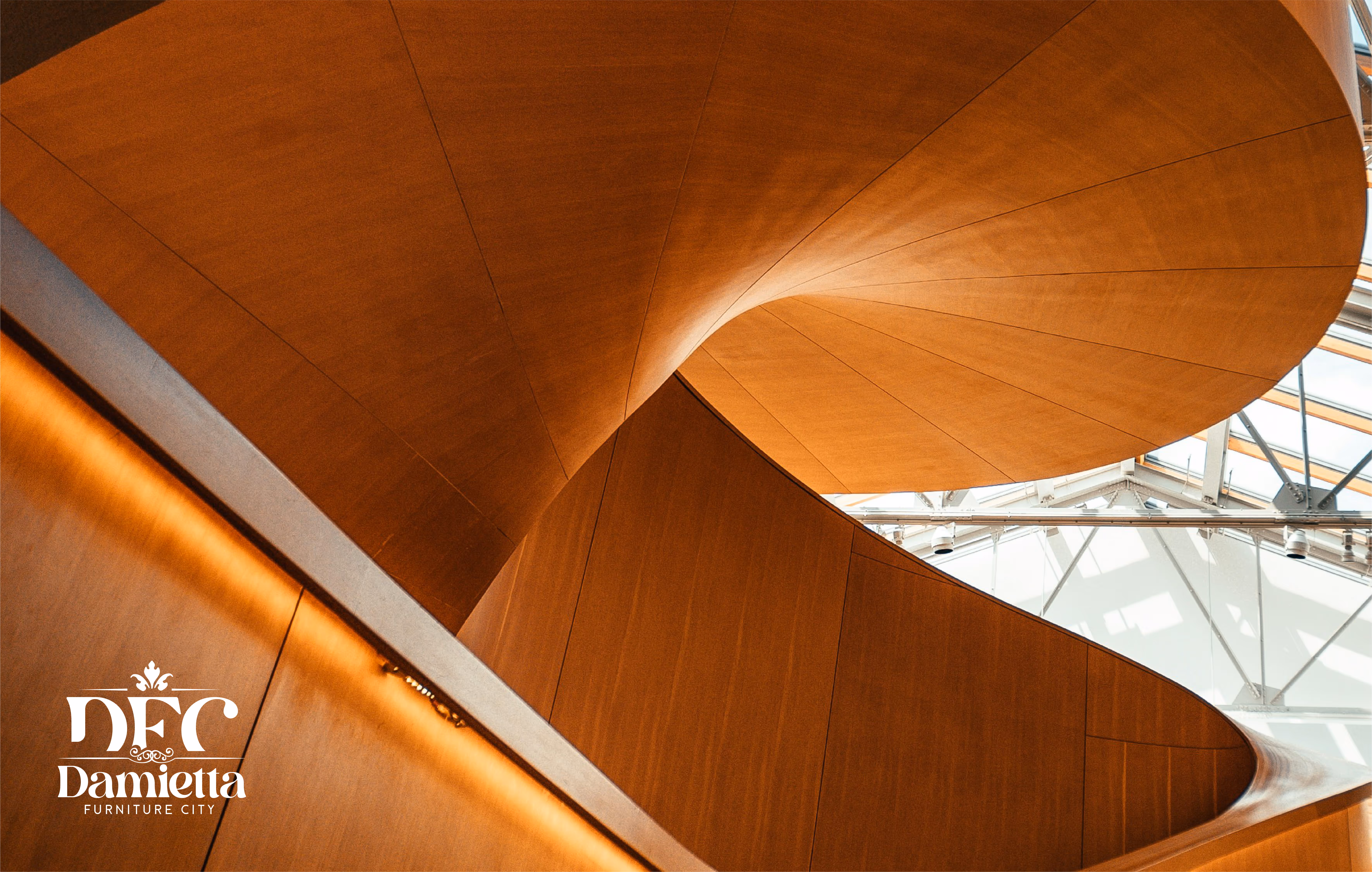 Curved wooden spiral staircase seen from below with glass ceiling above.