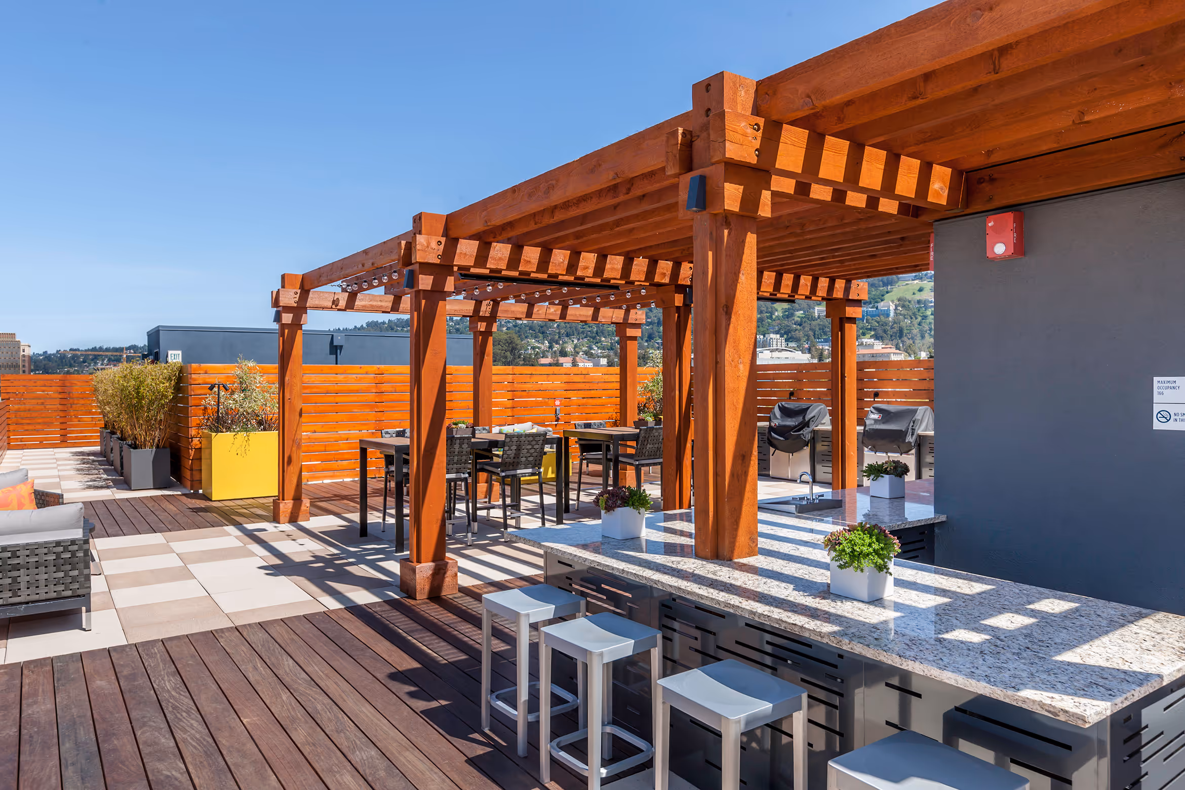 Roof top deck with grilling area with stainless steel grill with tables and chairs