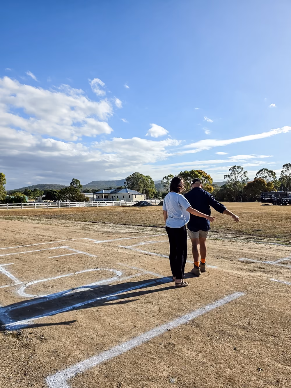People walking through a full-scale house layout marked on a North Queensland block.