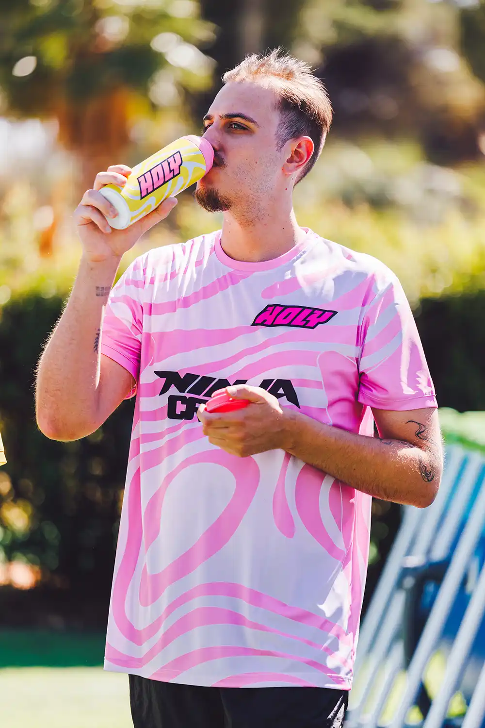 Hugo is going wild in a "Crazy Ninja" T-shirt by Holy while drinking from a Holy water bottle