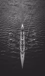 team rowing a boat together