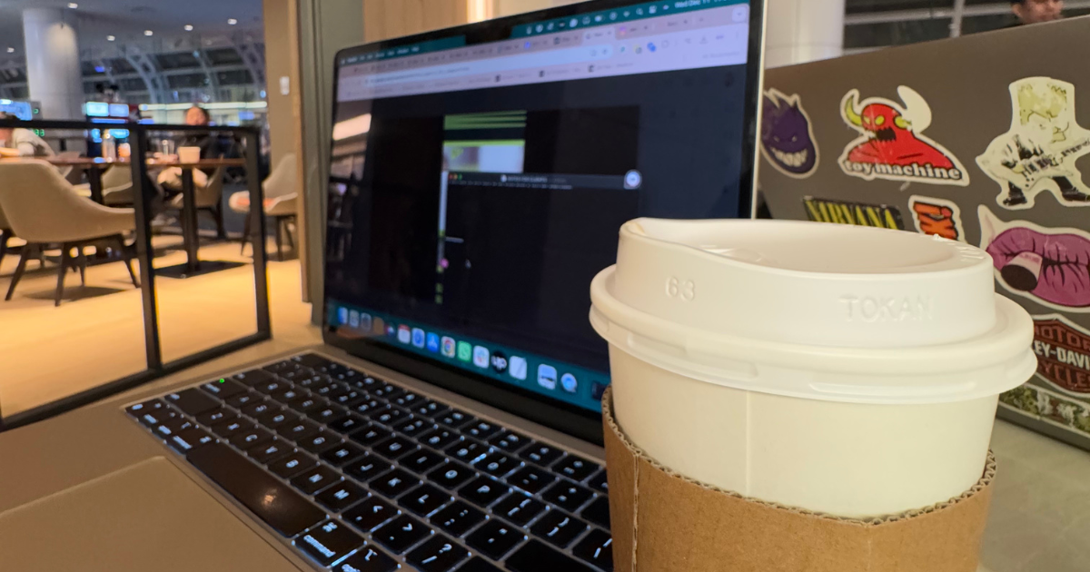 laptop and coffee in a cup on the table