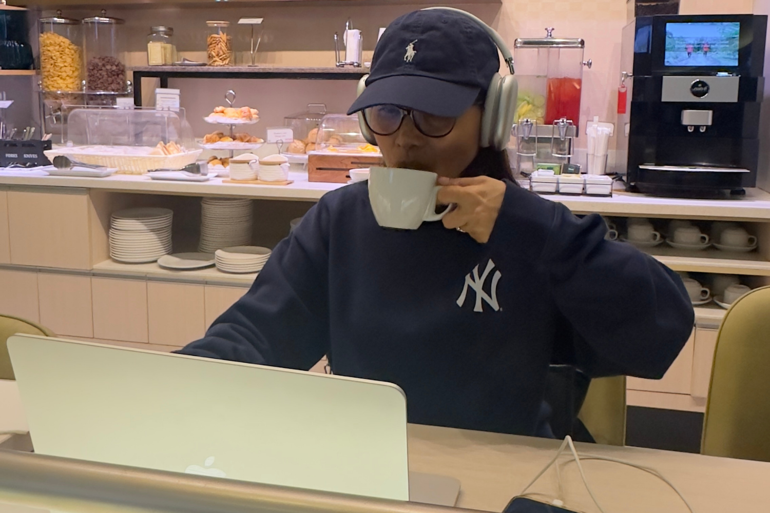 a woman working on her laptop at the airport lounge