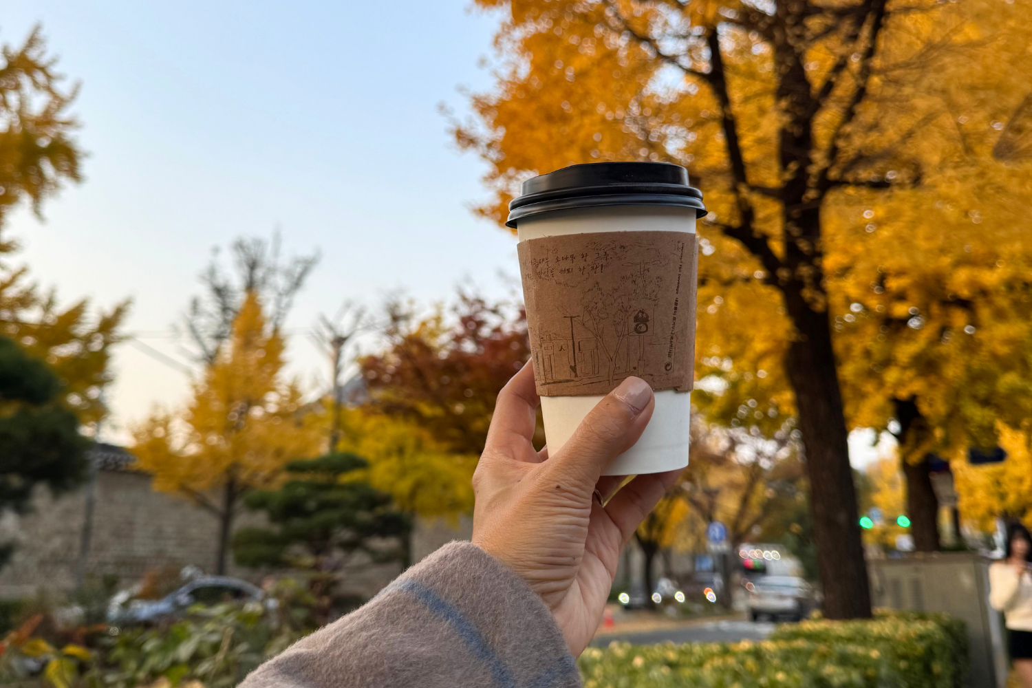 Coffee in hand during fall season in Seoul South Korea