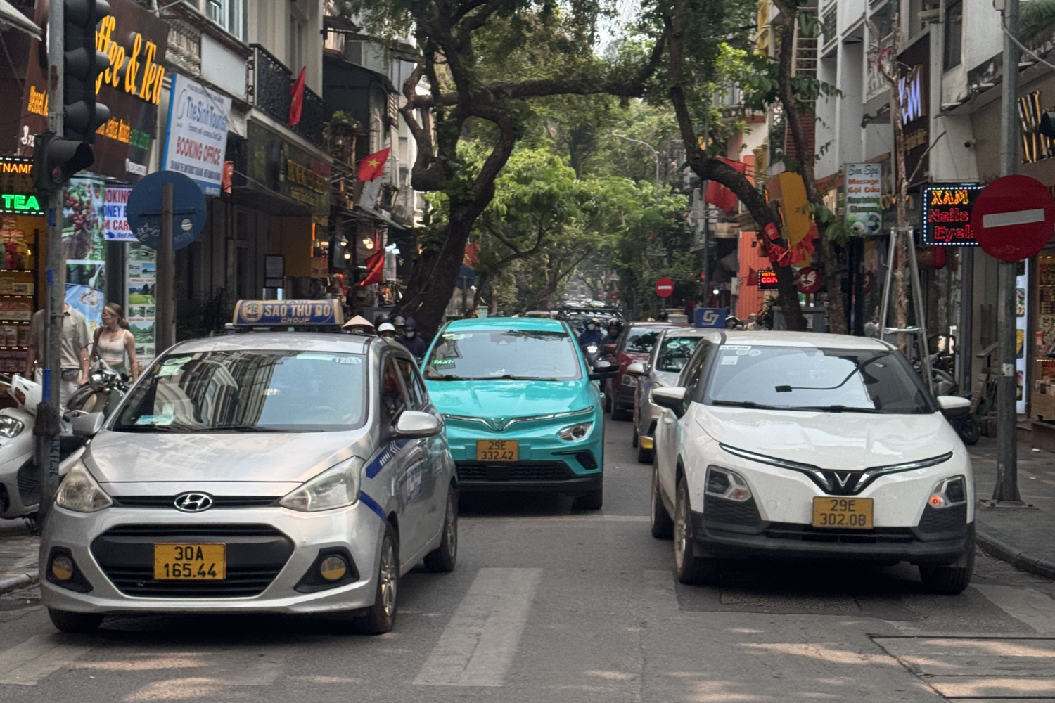 Busy Hanoi street traffic viewed from private transfer vehicle in Vietnam