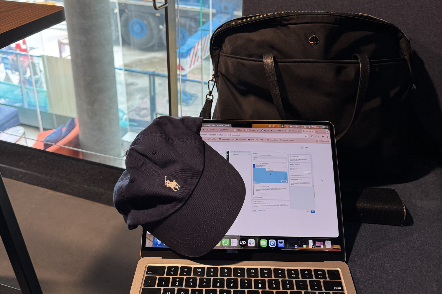 Laptop bag and laptop in workspace at Tru by Hilton Hanoi Station hotel.