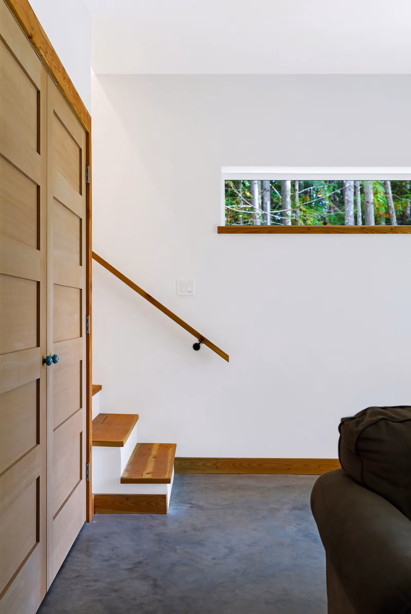 Interior living space of Forbidden Black showing dark-mode nordic aesthetic and airy vaulted ceiling