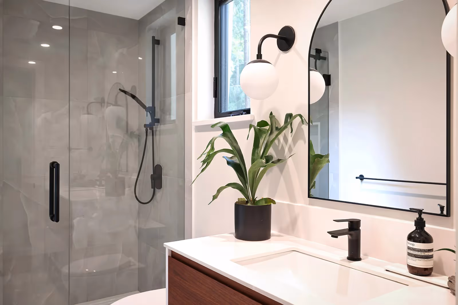 Custom bathroom with floating vanity, warm tile, and spa-like finishes in Pine Forest home