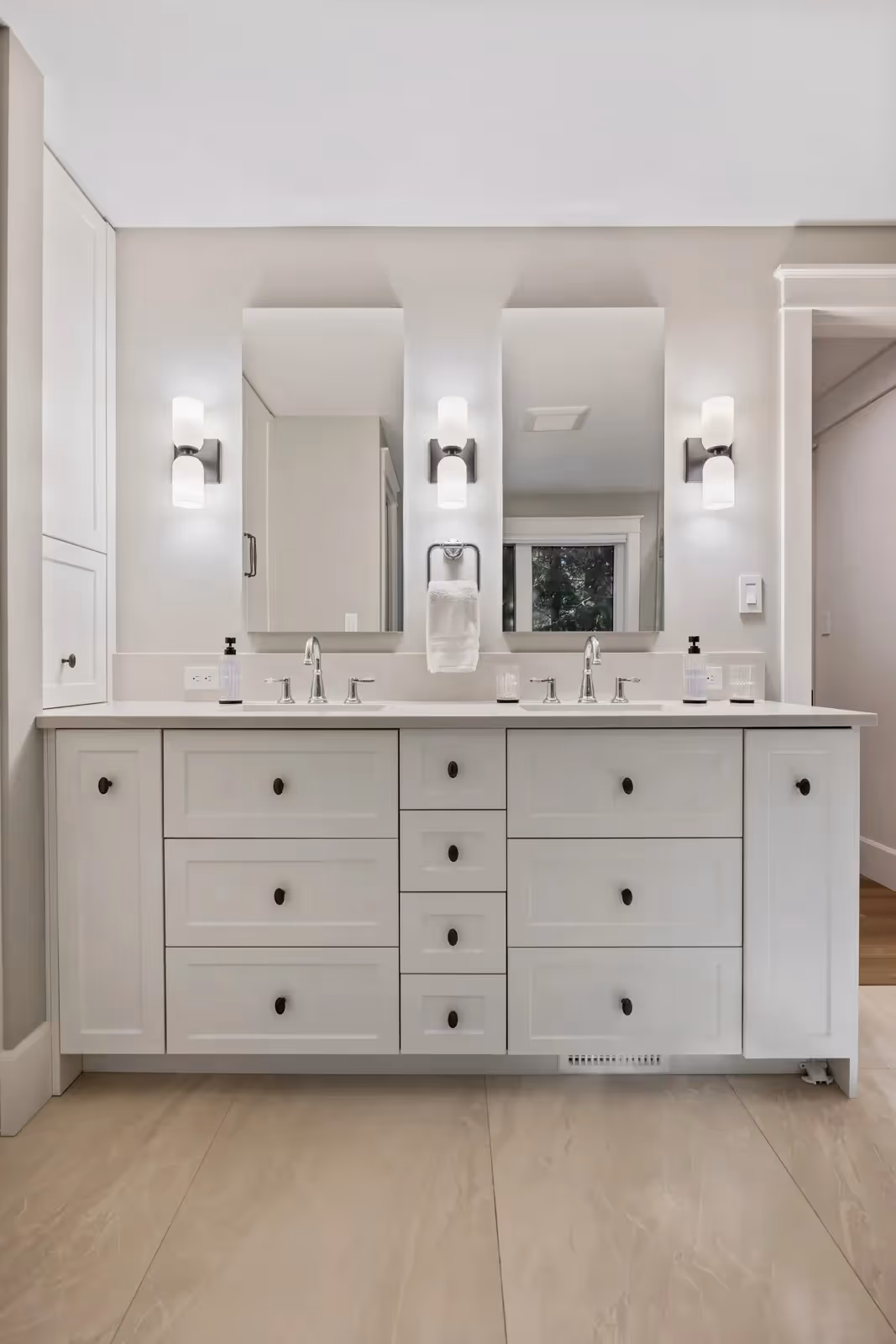 Transitional double vanity in Misty Bluff primary bathroom with custom millwork and warm wood tones