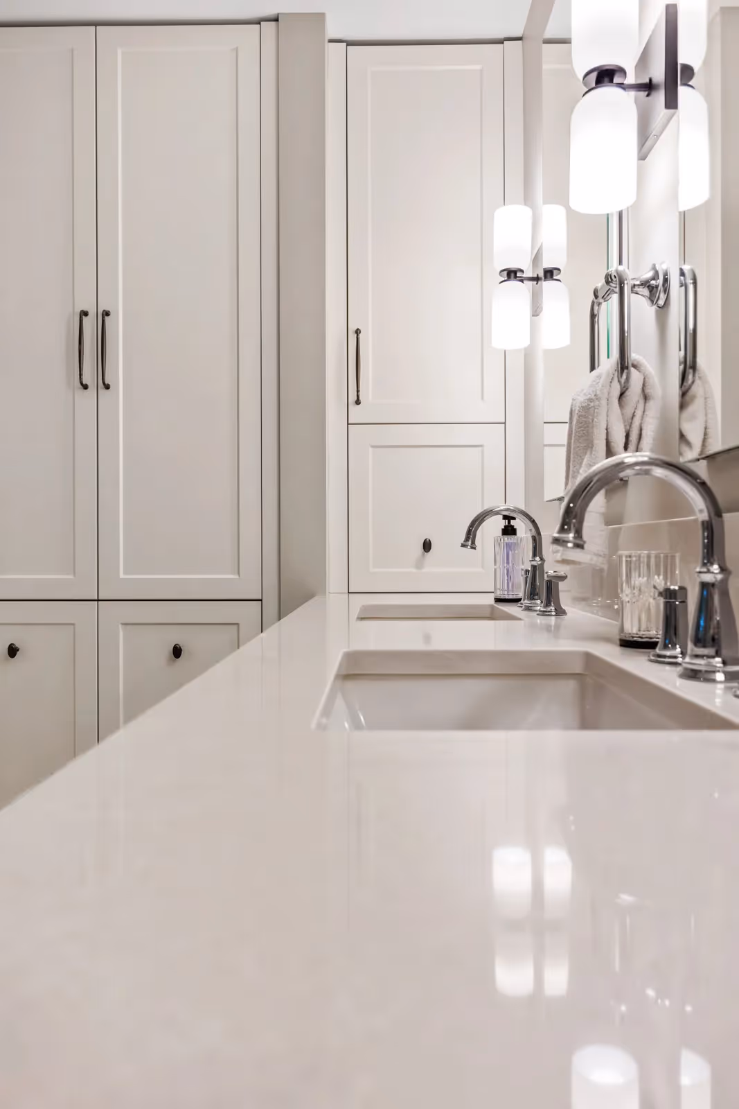 Custom double vanity detail with quartz countertop and brushed hardware in Misty Bluff bathroom