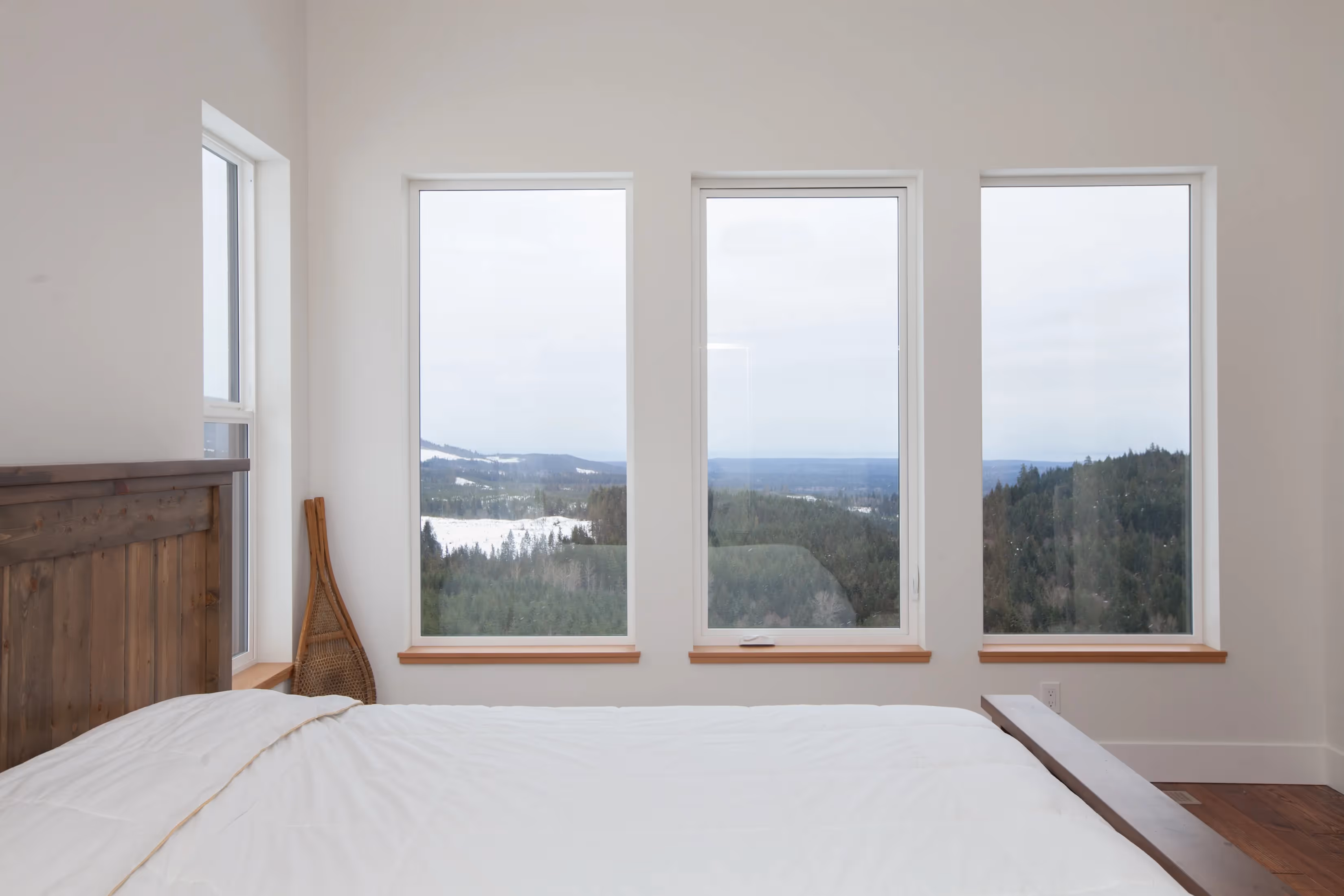 Full exterior view of The Edge custom home at Forbidden Plateau with mountain vistas and surrounding evergreen forest