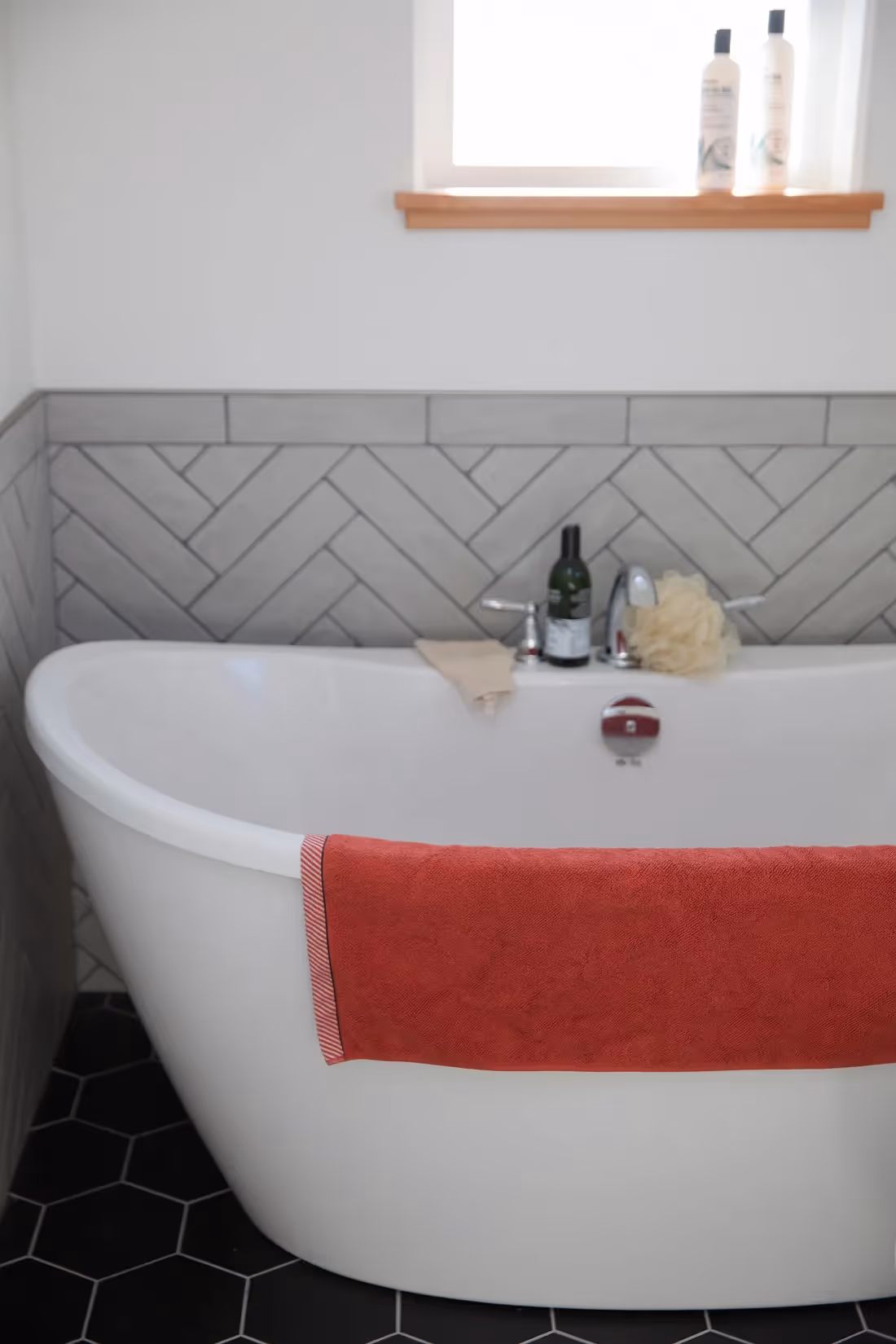 Freestanding white soaker tub in rebuilt Cumberland cottage with classic craftsman details