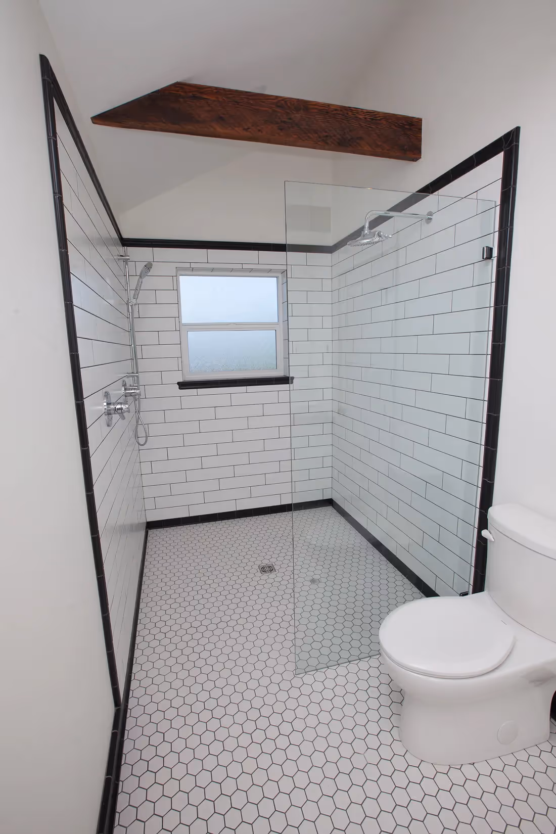 Classic subway tile shower in one of the rebuilt Cumberland heritage homes in From the Ashes project