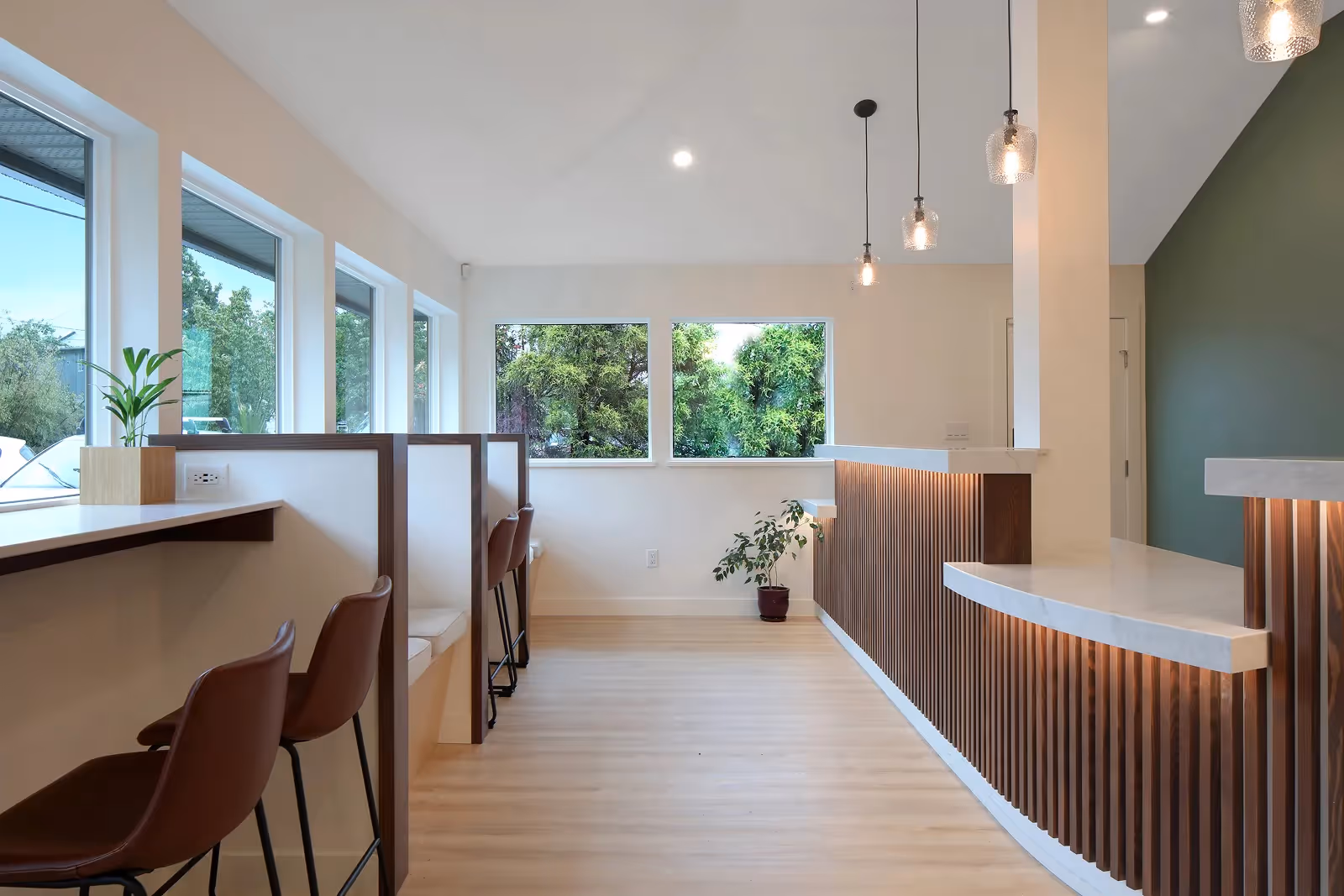 Open-plan office interior of Westward Medical Clinic with custom built-in planters, benches, and warm wood accents