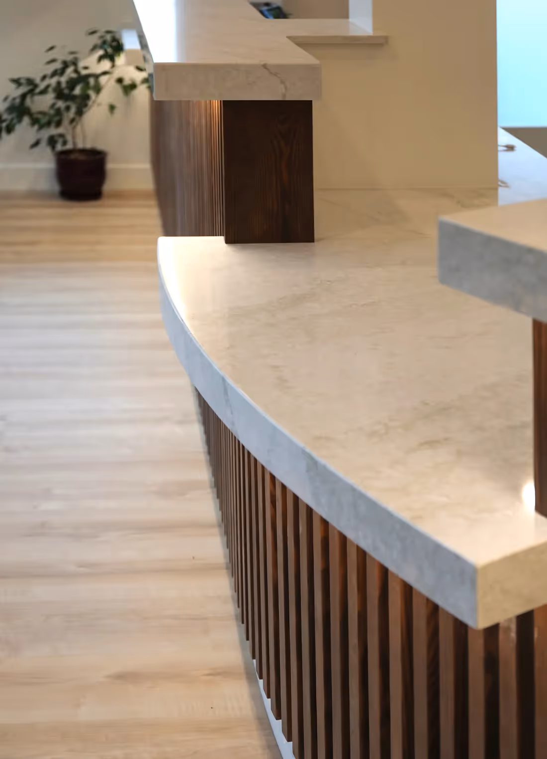 Reception desk with rhythmic vertical wood slat pattern in Westward Medical Clinic, Courtenay BC