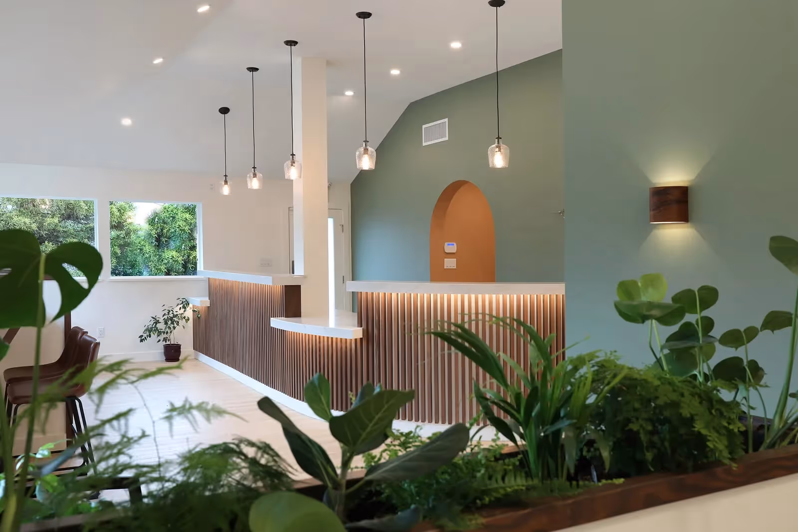 Westward Medical Clinic interior in Courtenay BC with curved wood feature wall and warm biophilic lighting