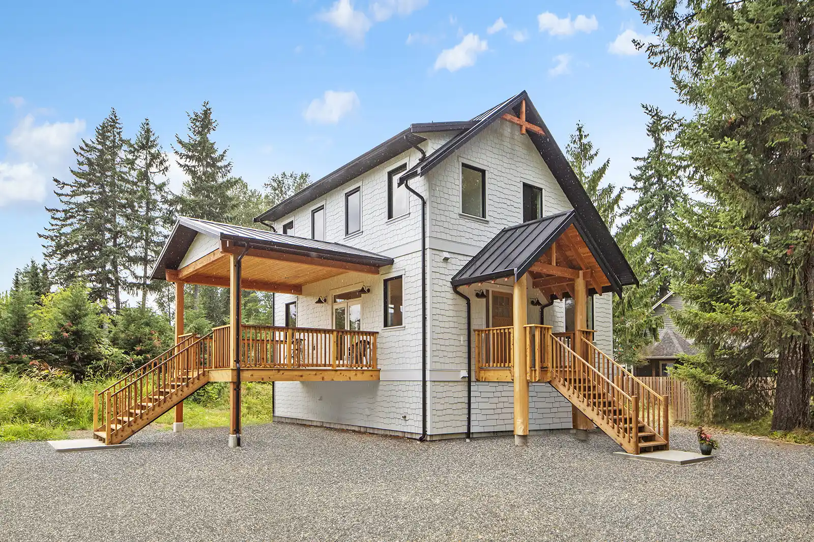 White Castle custom home exterior in Cumberland with vaulted roofline, grand covered entry, and bright white finishes