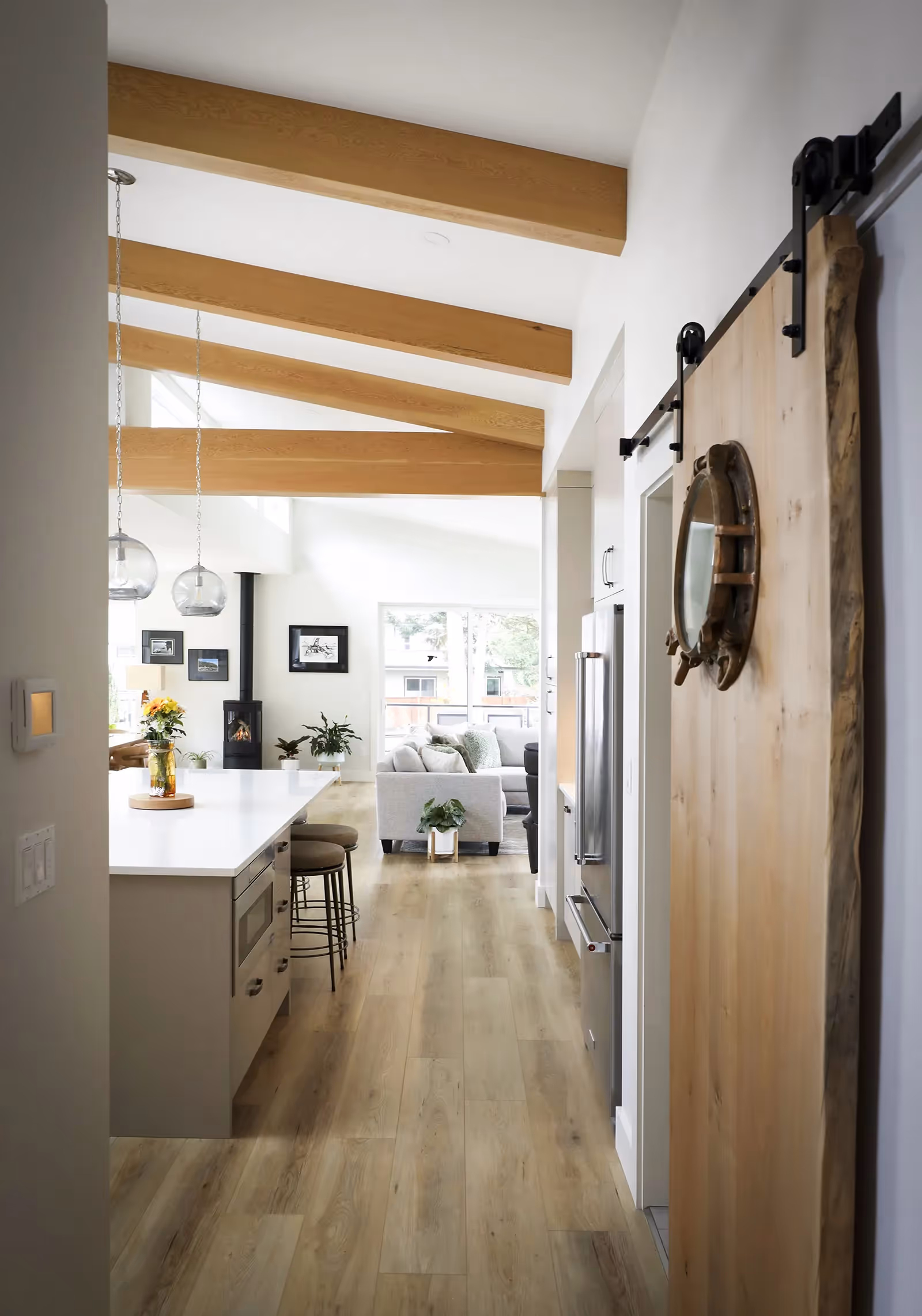 Vaulted ceiling with exposed wooden beams in Little River Landing open-concept living area