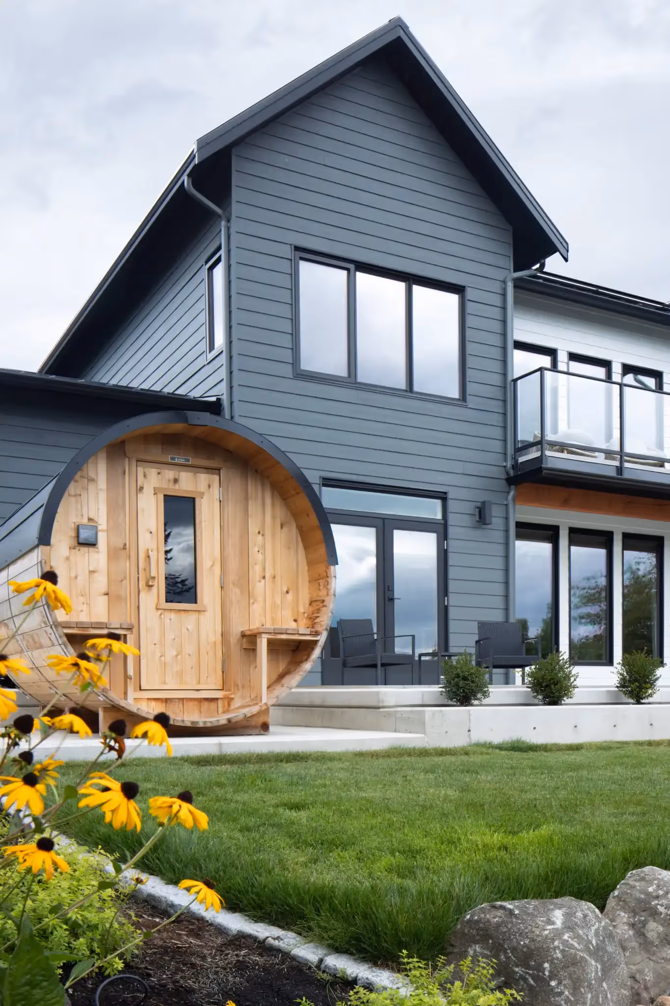 Front exterior of The Second Act custom home with archways, modern farmhouse styling, and refined landscaping