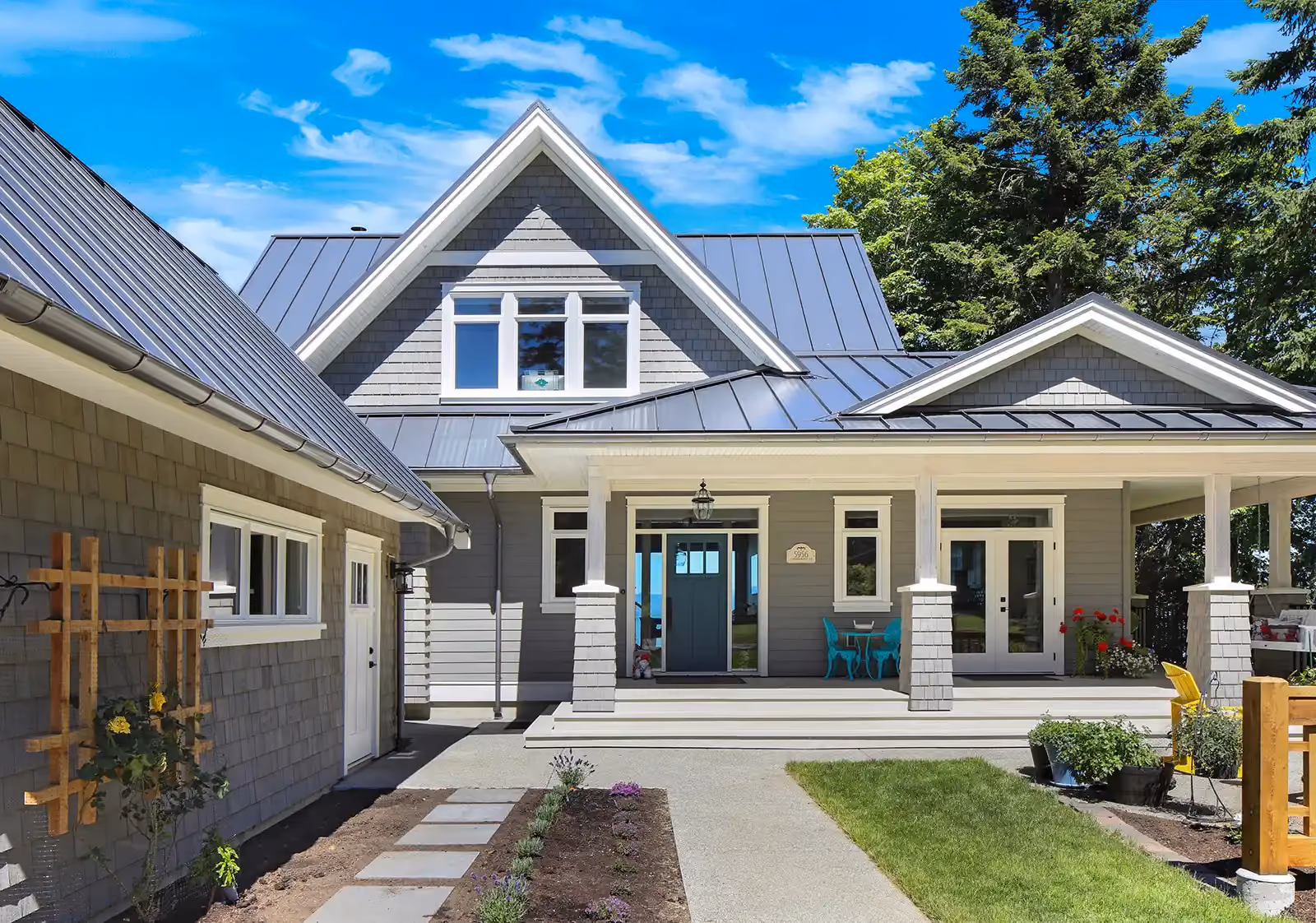 Full exterior view of Seabank Cottage with panoramic ocean backdrop and craftsman covered porch