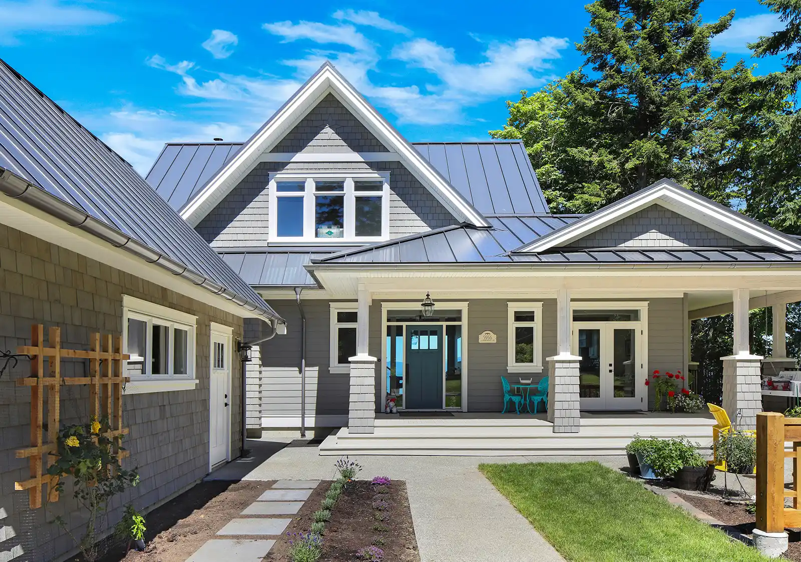 Full exterior view of Seabank Cottage with panoramic ocean backdrop and craftsman covered porch