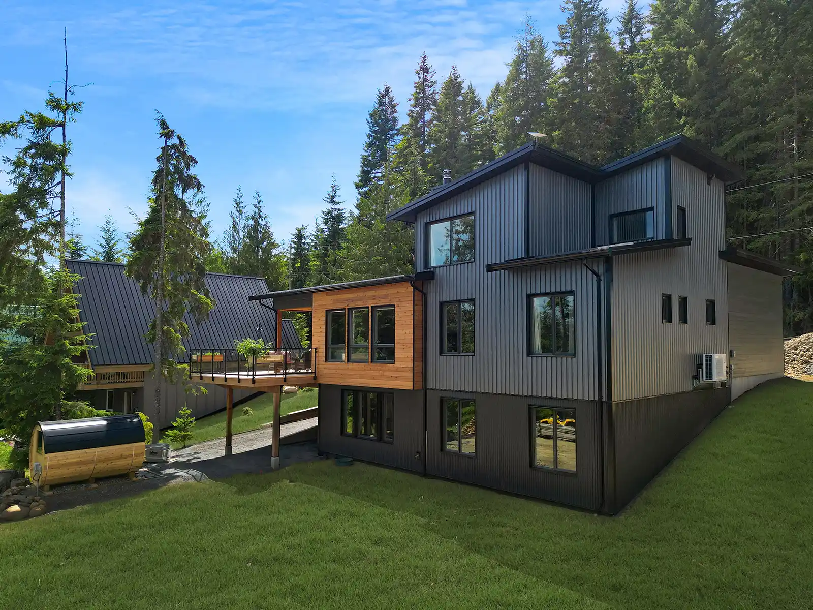 Mountain Mist custom home exterior at Forbidden Plateau with grey corrugated metal siding, timber accents, and mountain views