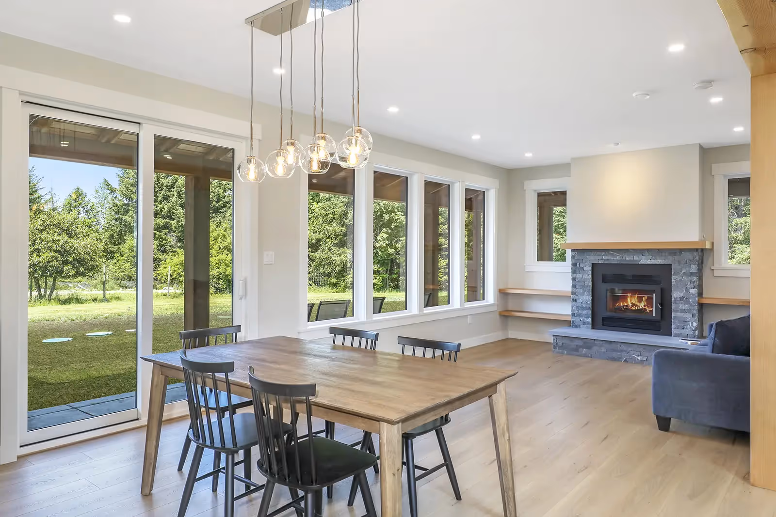 Expansive outdoor living space and covered entry of Sparrow Station with rural Comox Valley backdrop