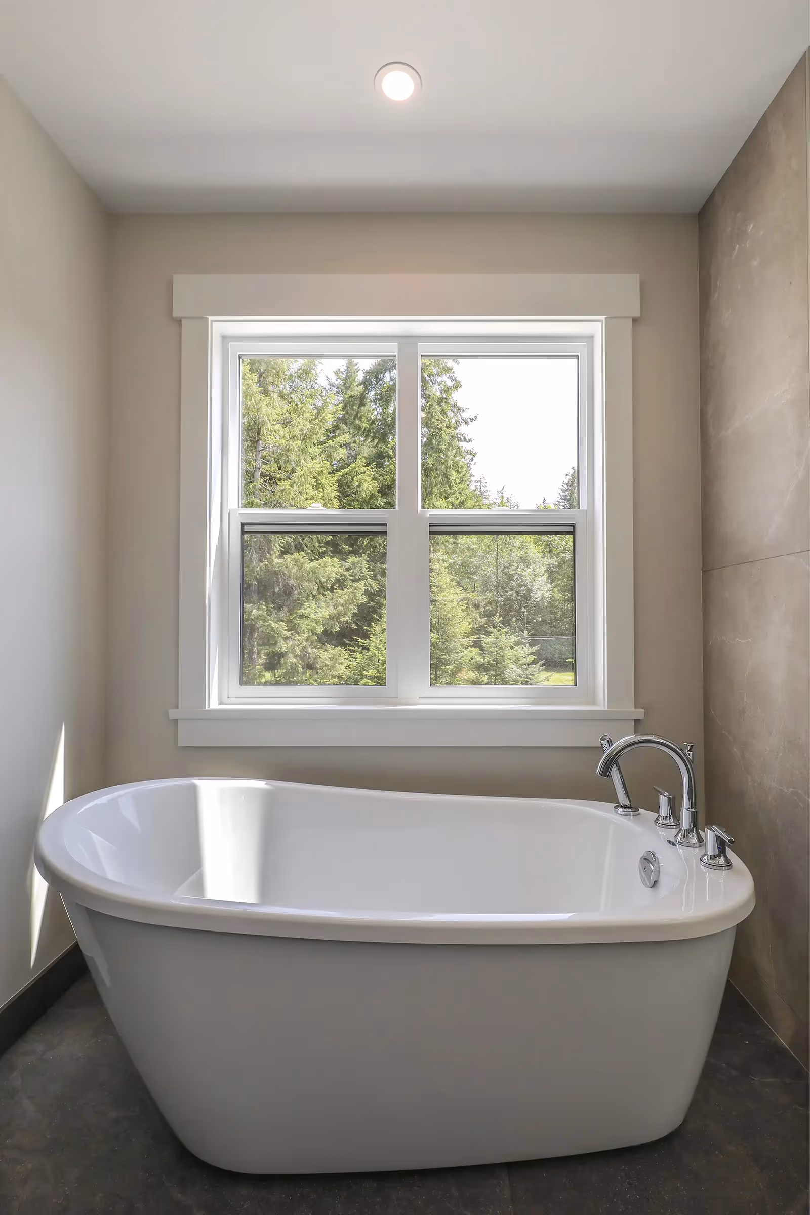 Mixed entry and laundry room interior in Sparrow Station with board and batten siding detail visible through windows