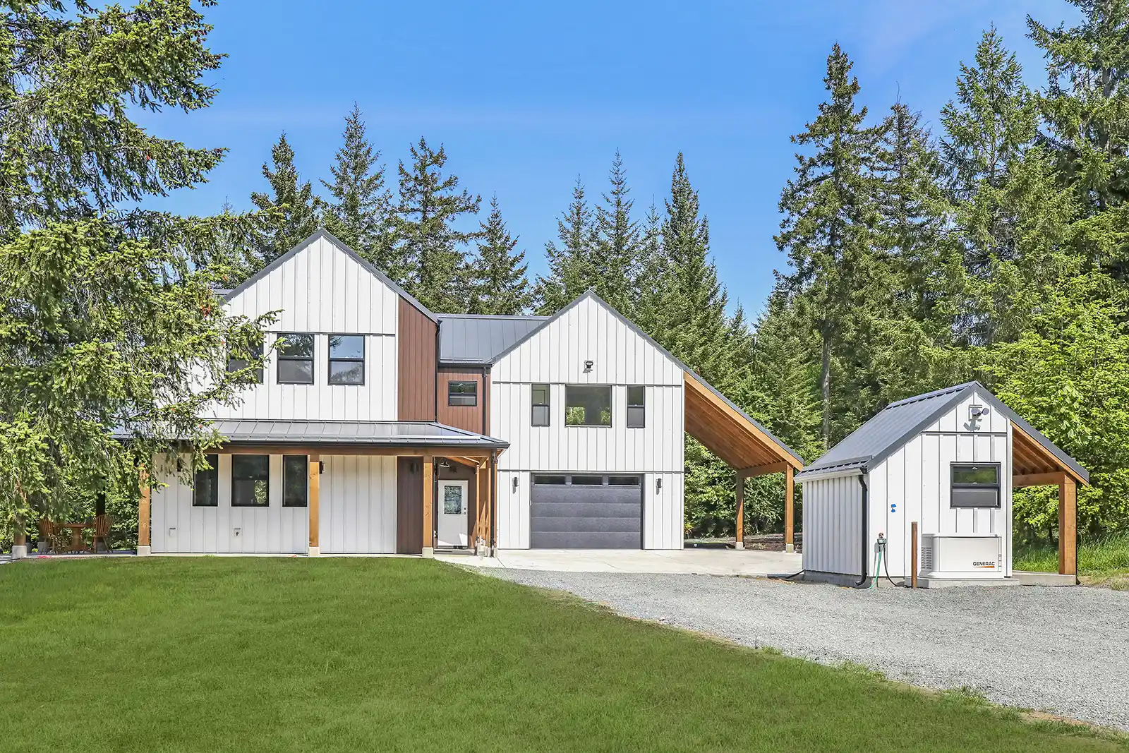 Street view of Sparrow Station custom home with white farmhouse exterior and views of fields and mountains beyond