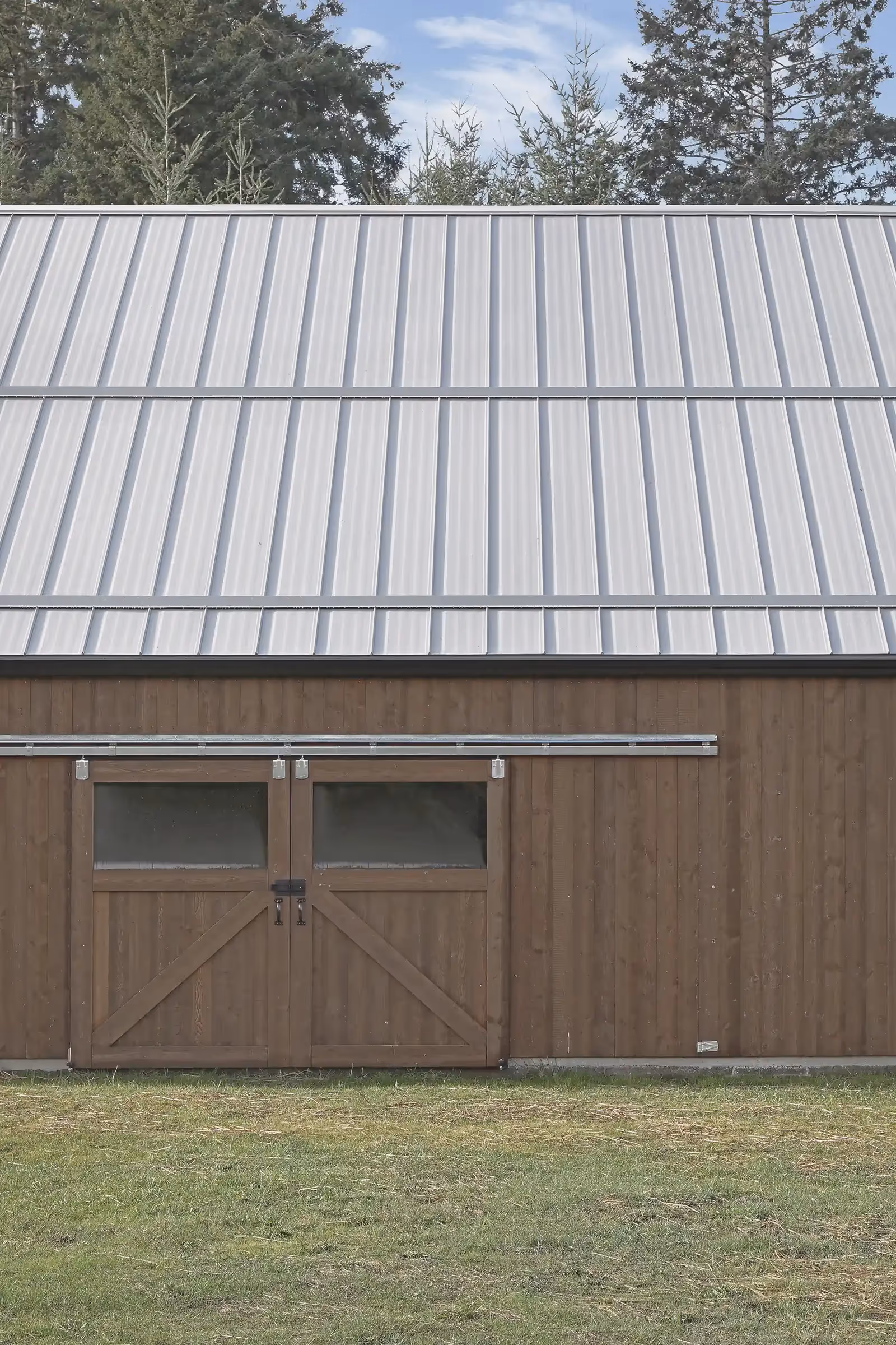 Exterior corner detail of Sparrow Grass Farm barn with black accents and contrasting wood siding combination